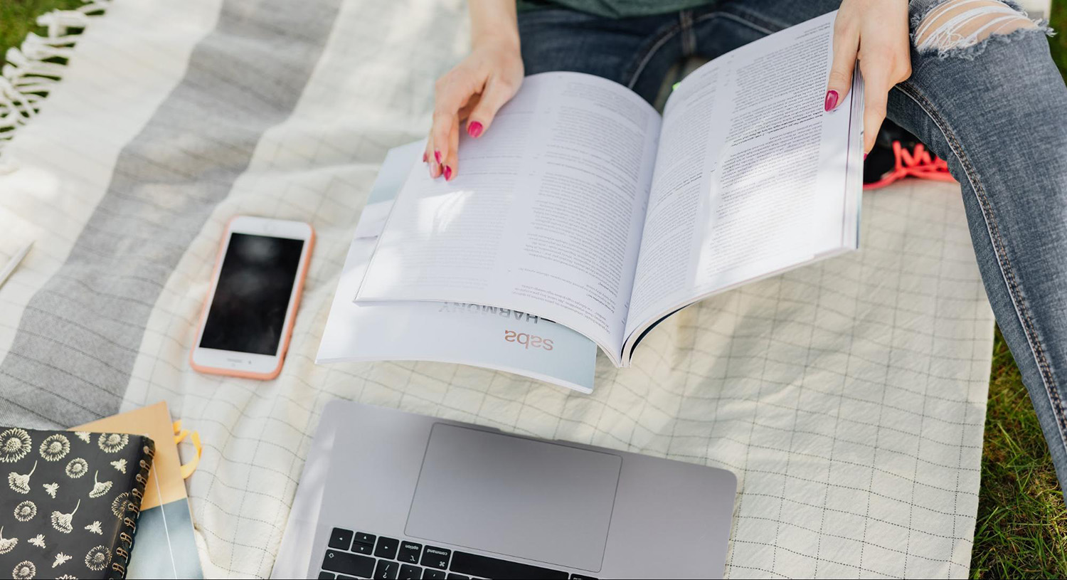 Student studying with a textbook outdoors